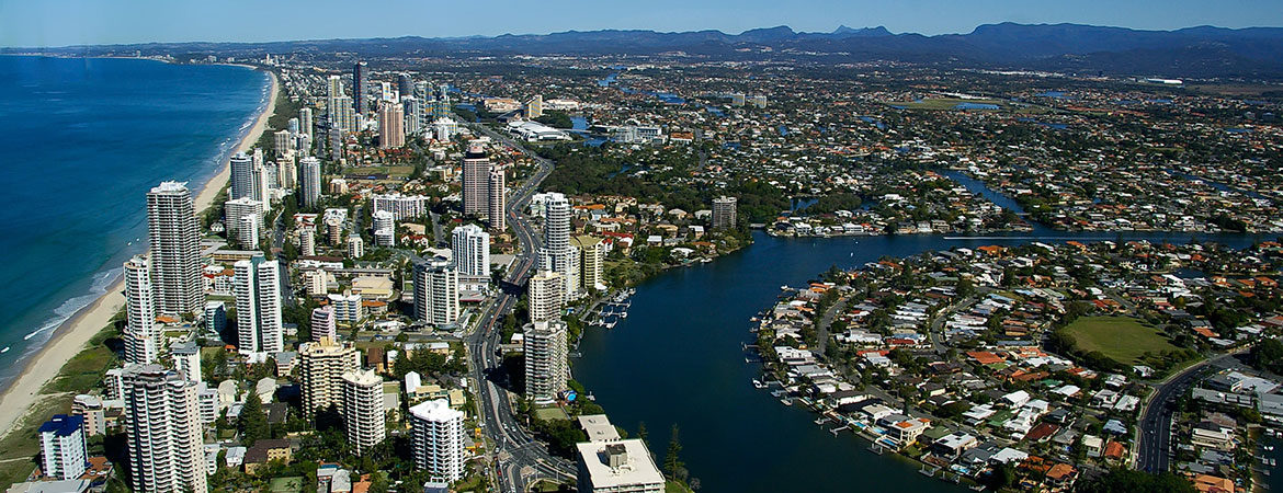 Aerial view of Gold Coast showing beach, highrise buildings, canals and homes